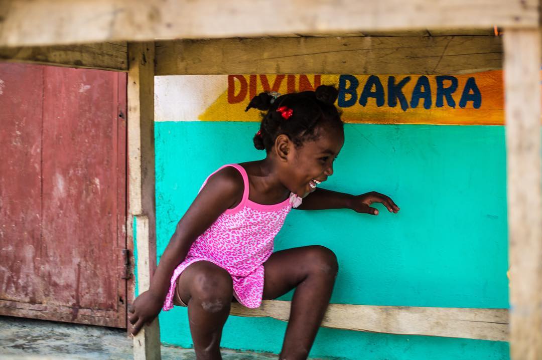 It has been another wonderful trip to Cange, Haiti and once again…the children drew my attention. Everywhere I looked, children were smiling and happy. As I pointed my camera to capture this little girl playing under a table, her shy retreat from showing her smile was proof of the hidden beauty inside this little mountain village. #Canon #5Dmkiii
